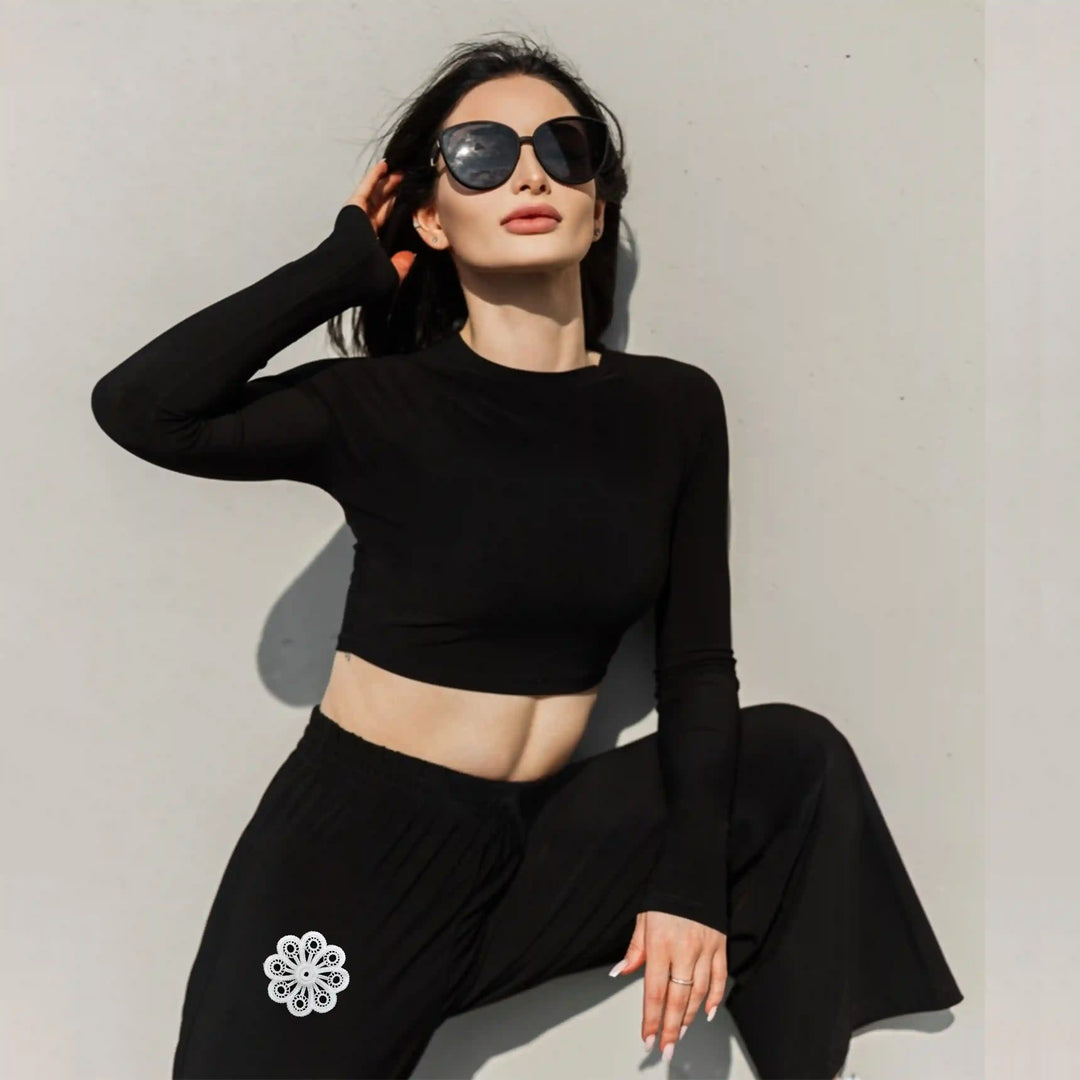 ANI Accessories small flower patch for clothes on black trousers worn by a seated model 