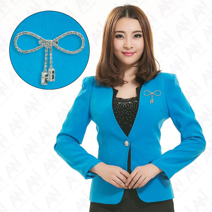 Sparkling Bow Brooch with Hanging Sapphire Two Stone showcased on a stylish blue blazer