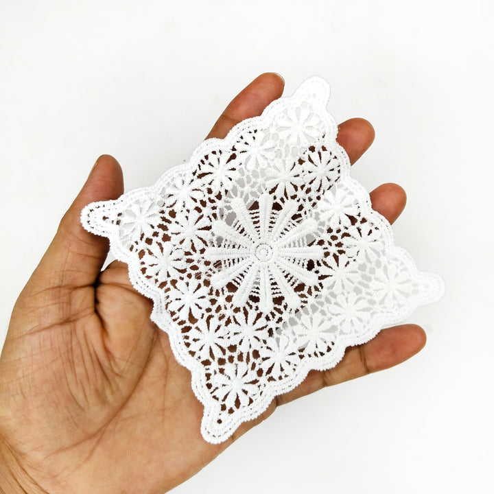 ANI Accessories square lace patch held in an open palm to show its 4 inch size 