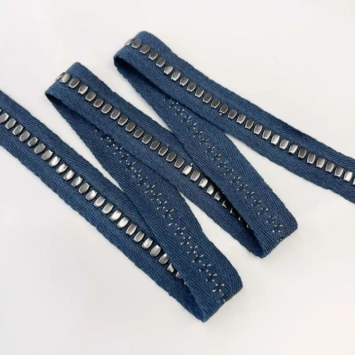 ANI Accessories studded tape trim with oval silver studs folded in a zigzag 