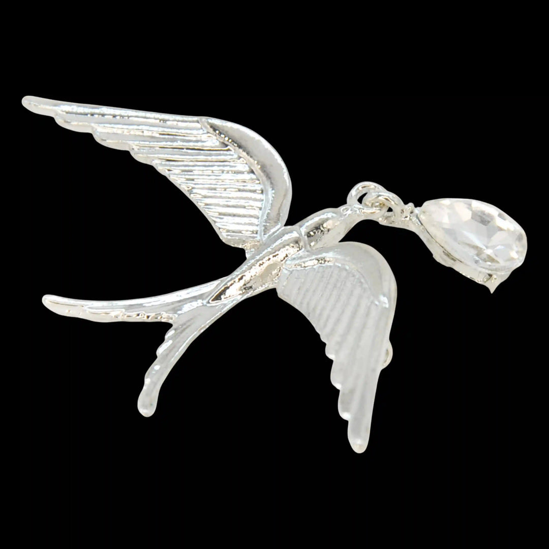 Silver swallow bird brooch with crystal drop on a black background 