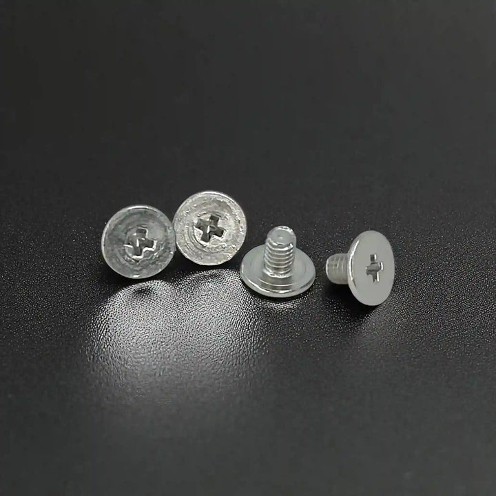 Screw fittings used to attach the tiger head emblem to fabric with white color background 