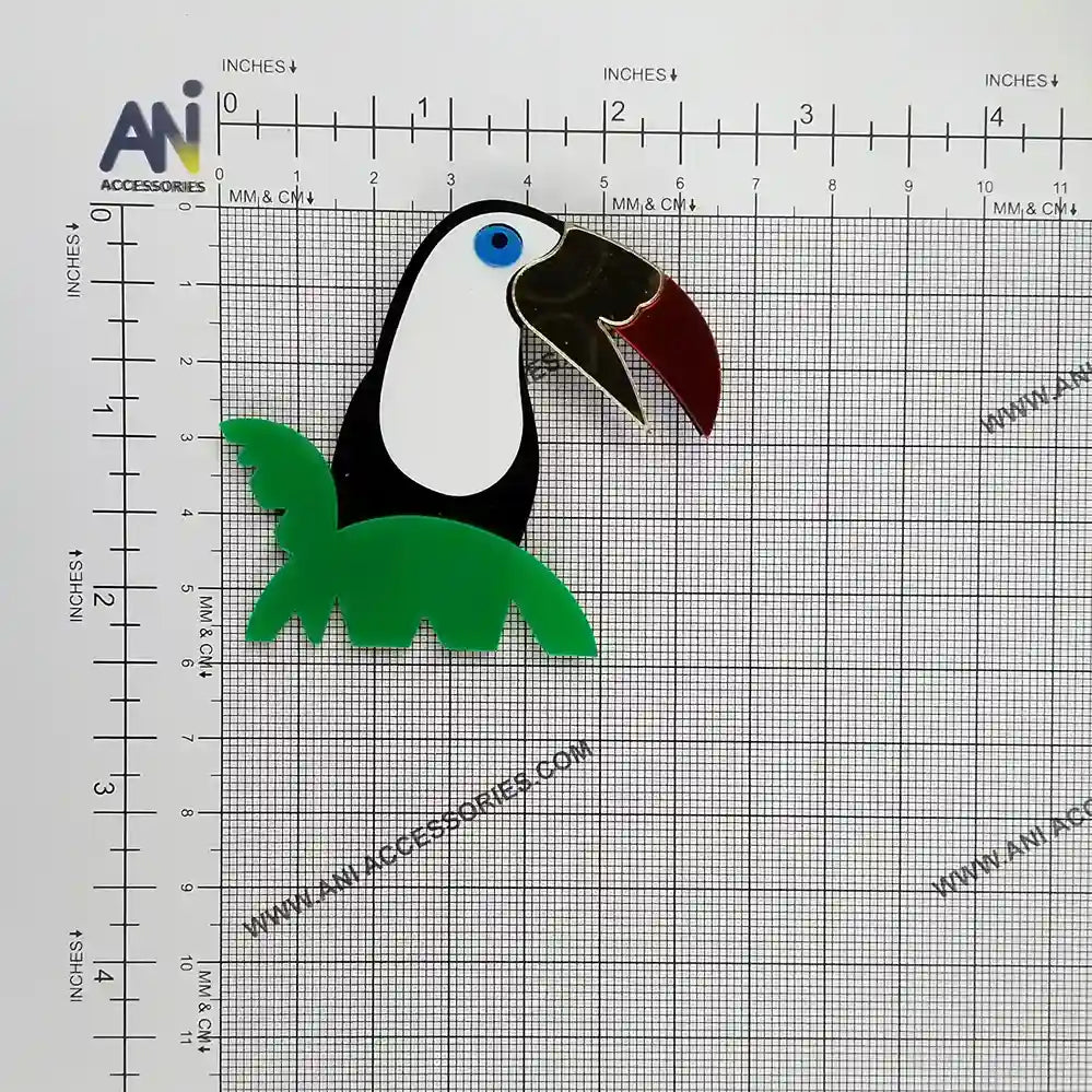 Stylized toucan brooch on a measuring grid, about 6.5 x 5.8 cm 