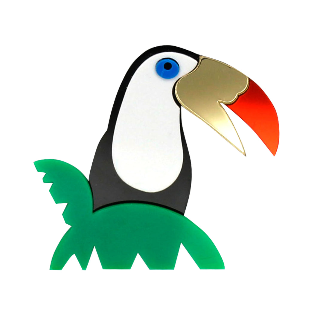Colourful acrylic toucan bird brooch with green tropical leaves with white color background 