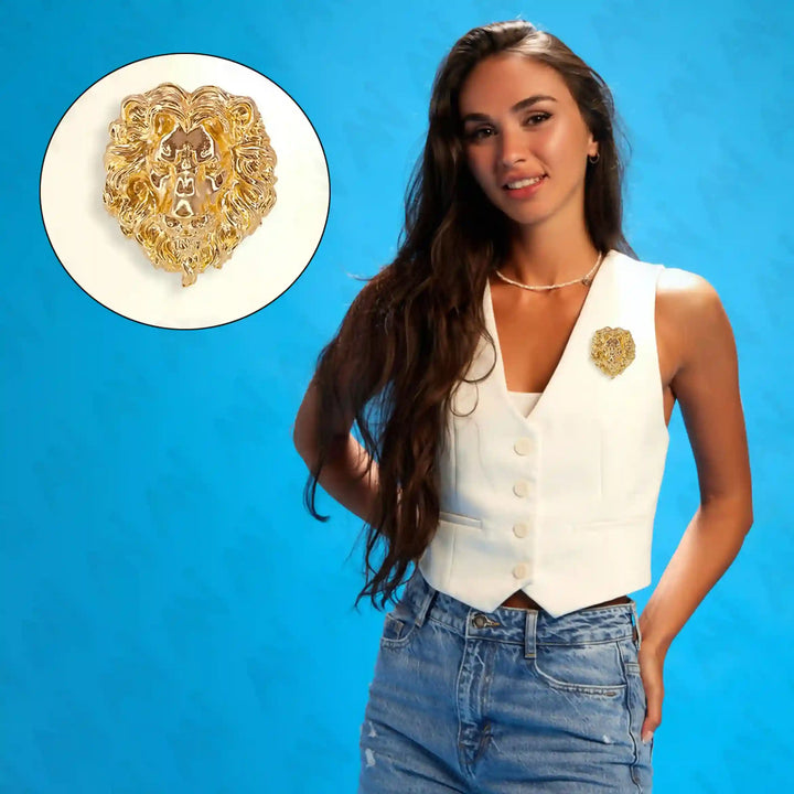 Gold lion brooch featured on a stylish model wearing a white vest and jeans