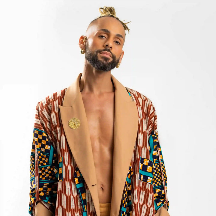 Stylish man wearing an ornate jacket with a lion head gold brooch for a trendy look