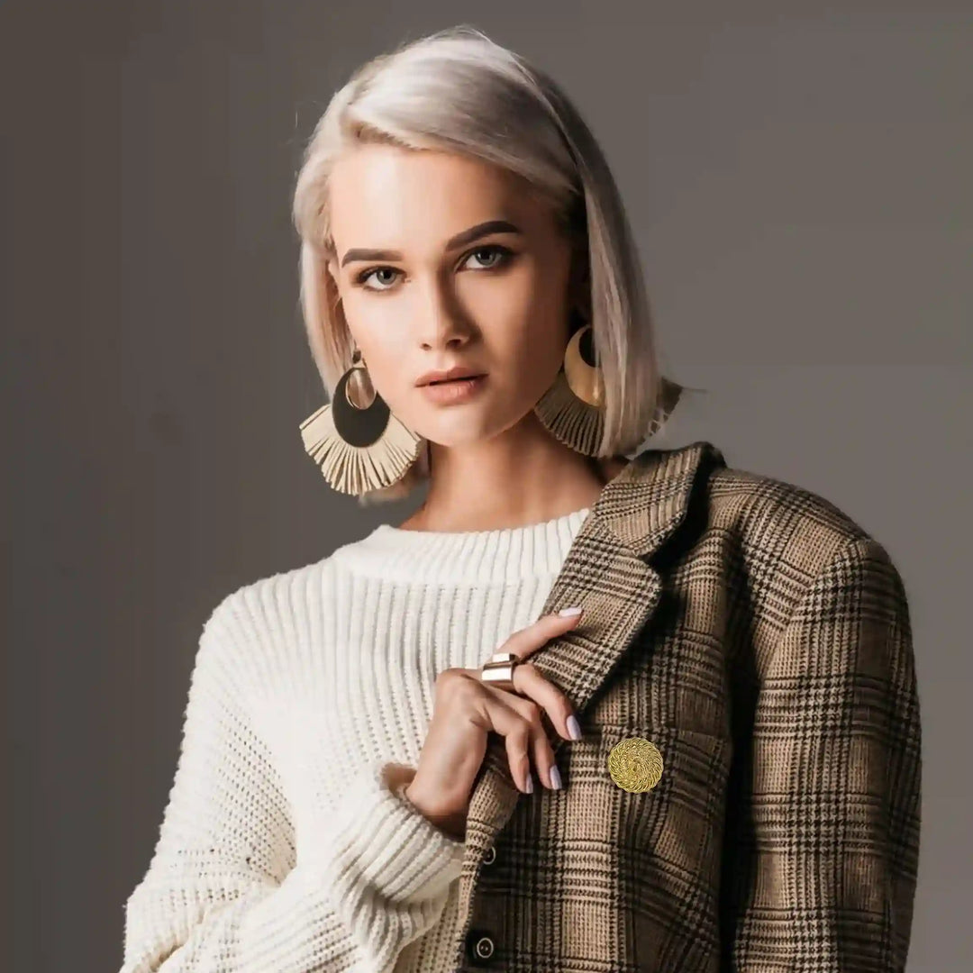 Stylish model wearing a lion head gold brooch on a plaid blazer for a chic look