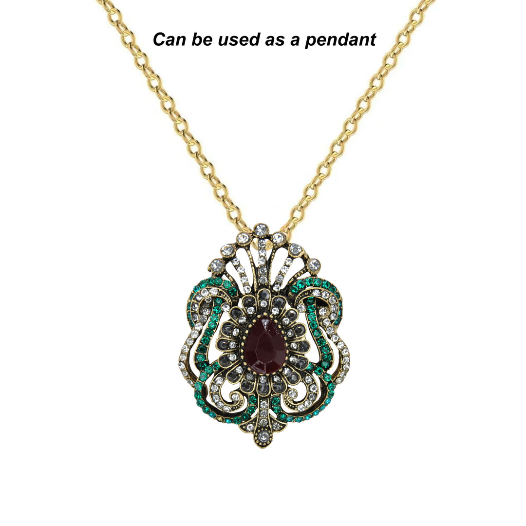 ANI Accessories Victorian brooch worn as a pendant on a gold chain with white color background 