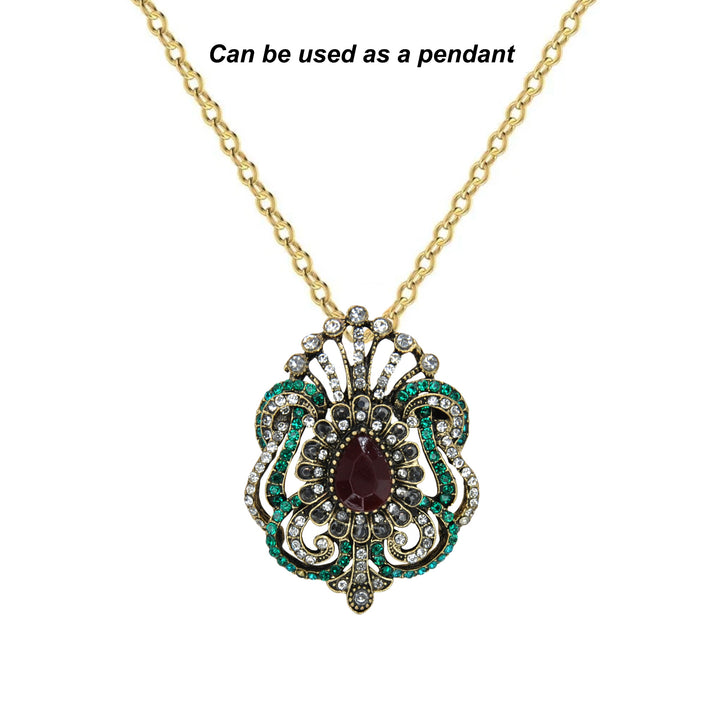 ANI Accessories Victorian brooch worn as a pendant on a gold chain with white color background 