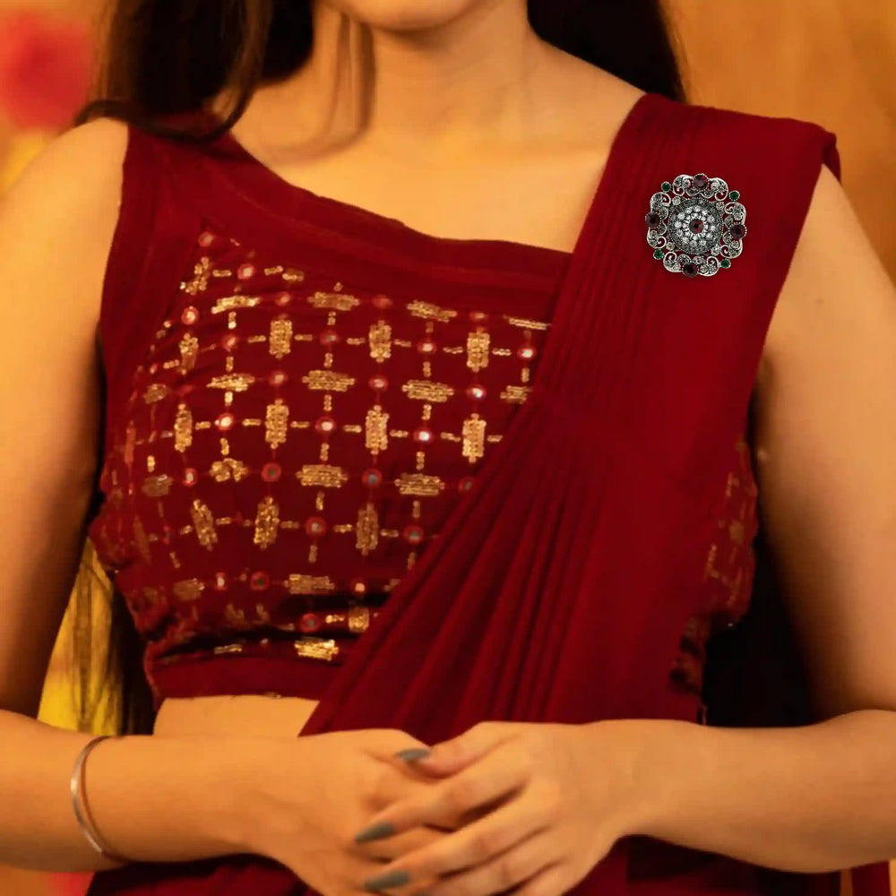 ANI Accessories vintage crystal brooch pinned on the shoulder of a red saree 
