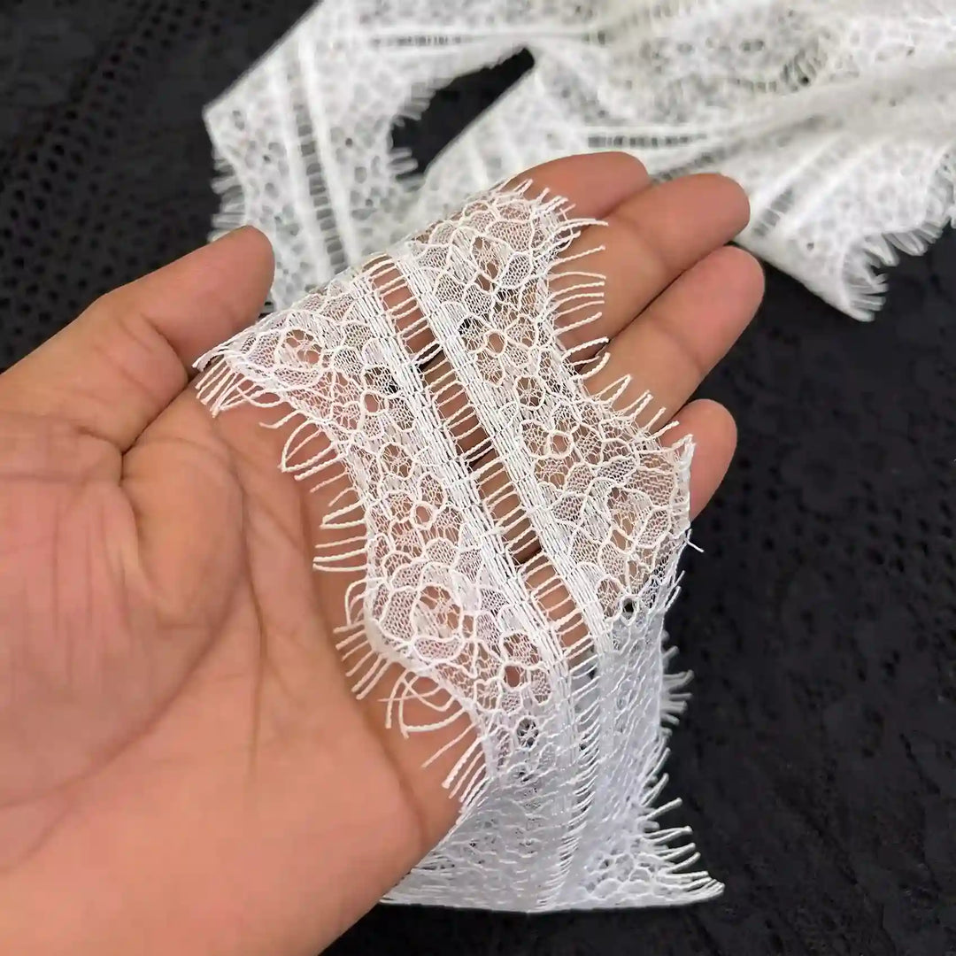 ANI Accessories white eyelash lace trim held in hand to show the ladder centre 