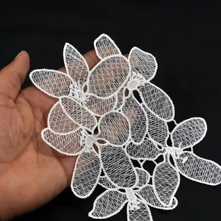 ANI Accessories white flower cluster patch held in a hand to show its size and thread work 