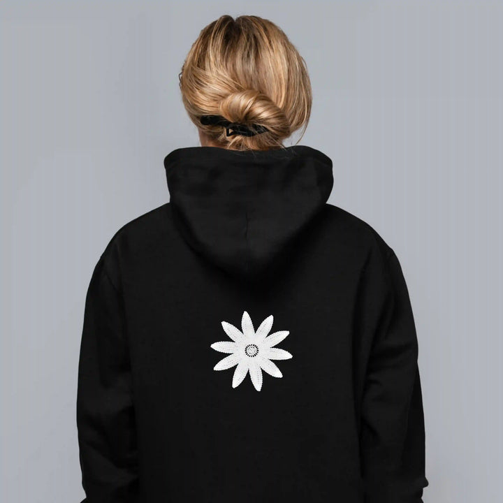 ANI Accessories white daisy flower patch stitched on the back of a black hoodie with Gray color background 