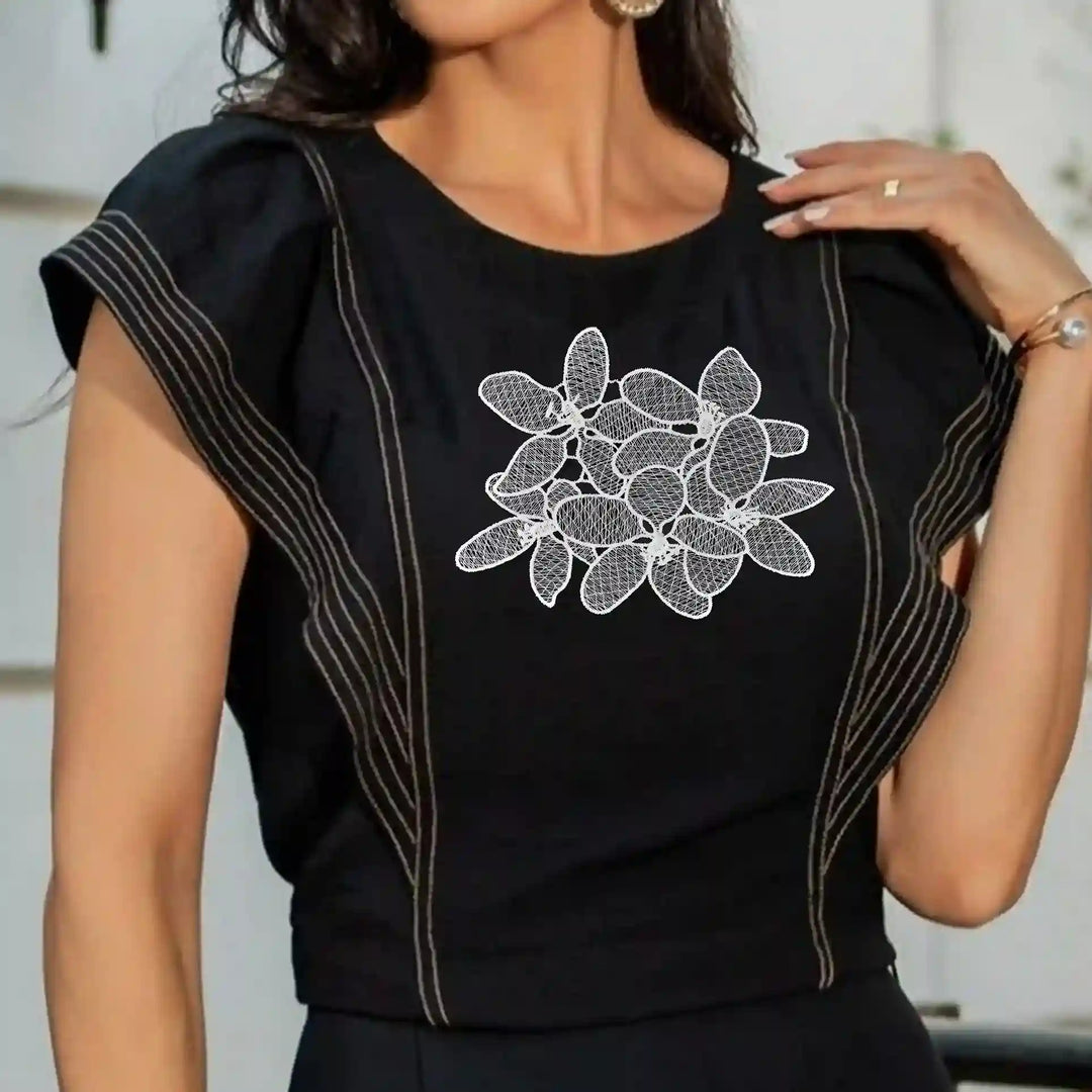 ANI Accessories white flower patch stitched on the chest of a black top 