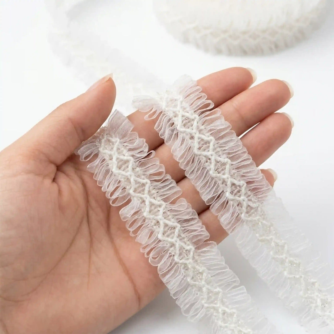 ANI Accessories white frill lace held in hand to show the sheer loops with white color background 