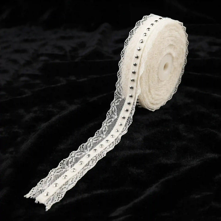 ANI Accessories white lace border with silver studs on a roll with black color background 