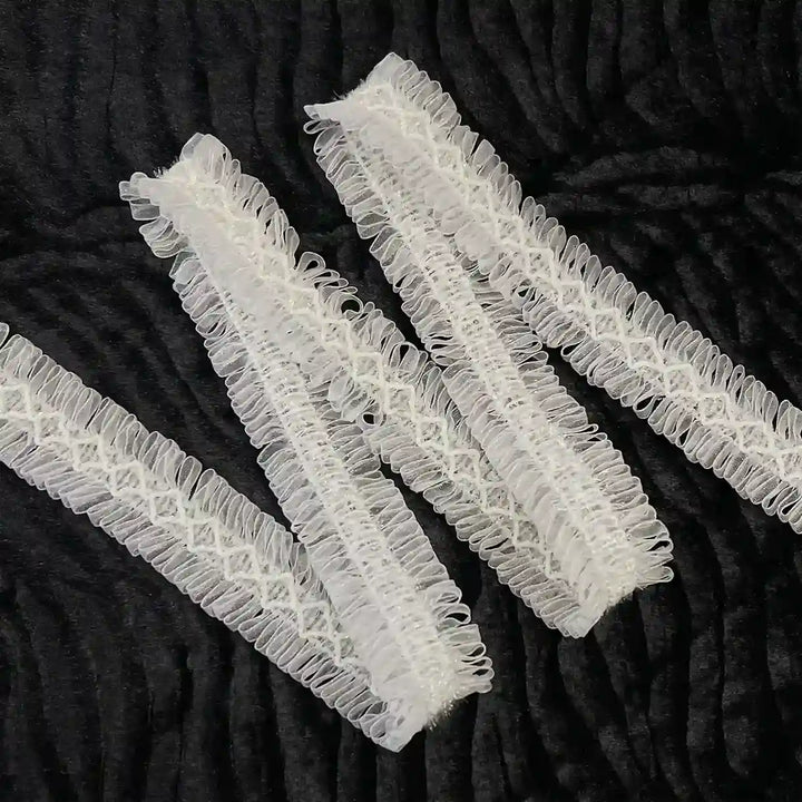 ANI Accessories white loop lace border folded in a zigzag on black background 