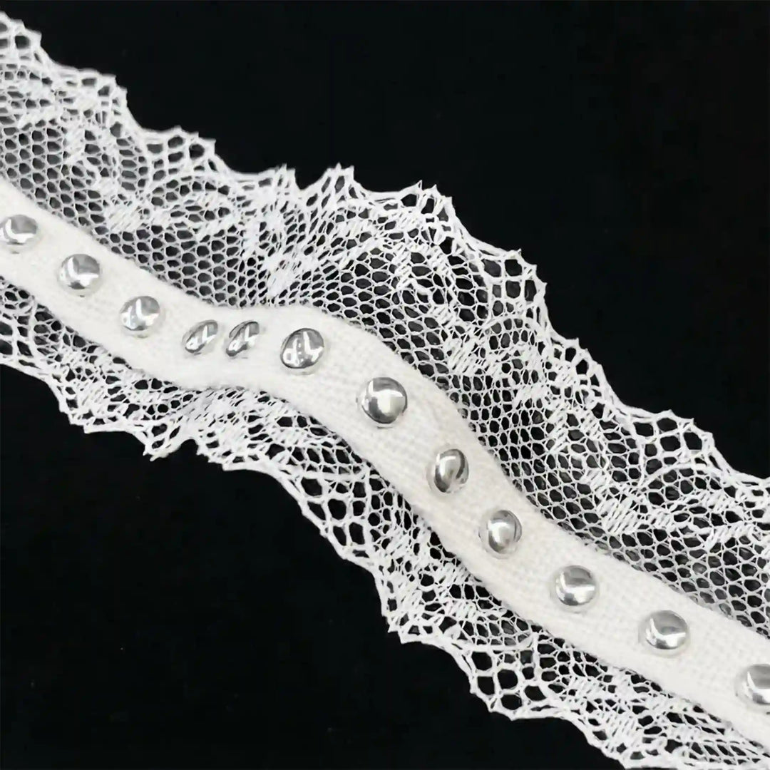 ANI Accessories close-up of white net lace with studs on a polyester tape with black color background 