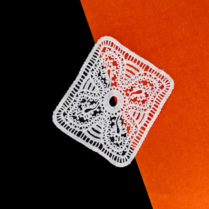 ANI Accessories white pocket patch tilted on a black and orange background 
